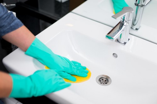 Cleaning operative checking a workplace area for hazards