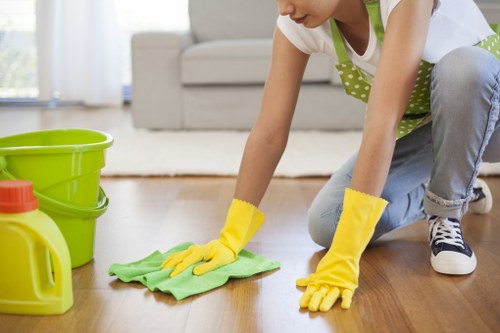Office cleaning staff sanitising desks in an N1 workplace